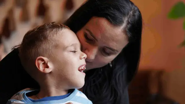 Smiling student with his mom