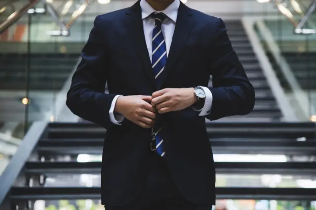 person standing near the stairs in a suit