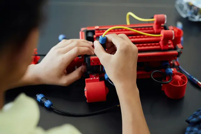 A young person doing his robotics project