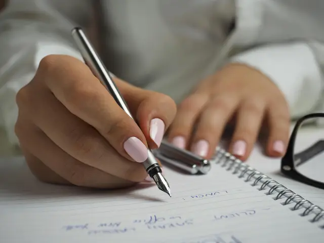A person writing in a notebook