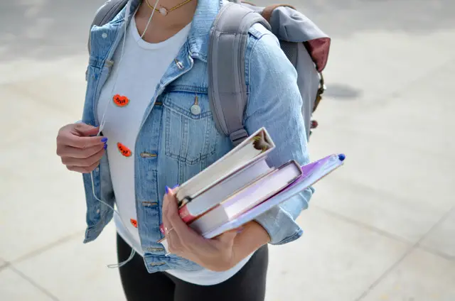 a girl holding books