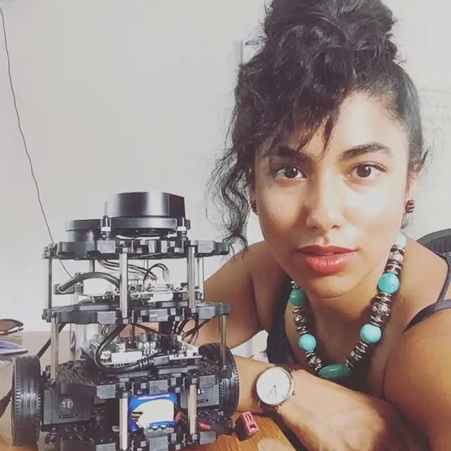 Student next to small robot