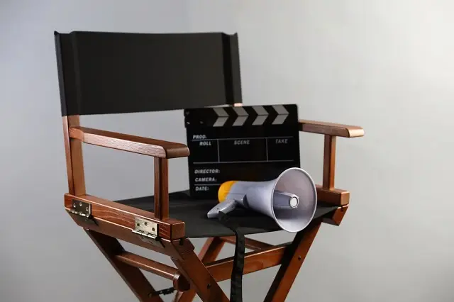 Film director's chair with clapperboard and megaphone.