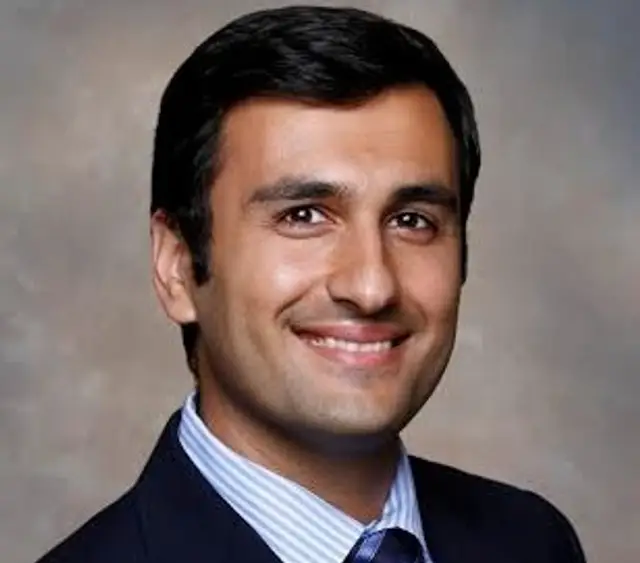 headshot of a man in a suit