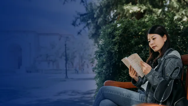 Female student reading at Stanford campus