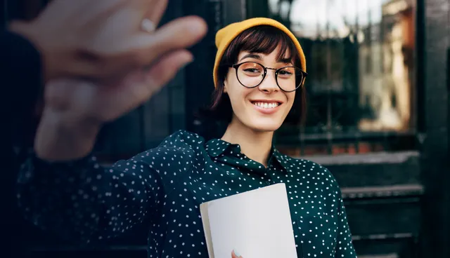 Student smiling giving a high five