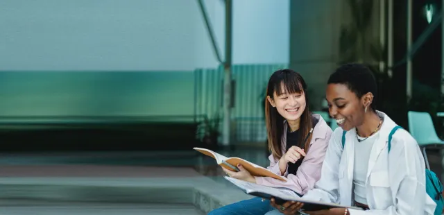 Happy student and mentor discussing their Polygence project